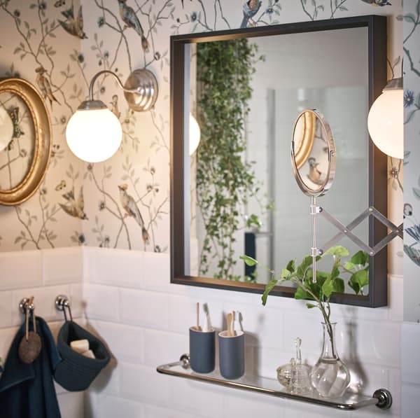 IKEA LILLHOLMEN nickel plated wall lamps emit a warm glow, while FRÄCK extendable mouted mirror has two different magnifications on each side of the glass so you can really see the details of your face.