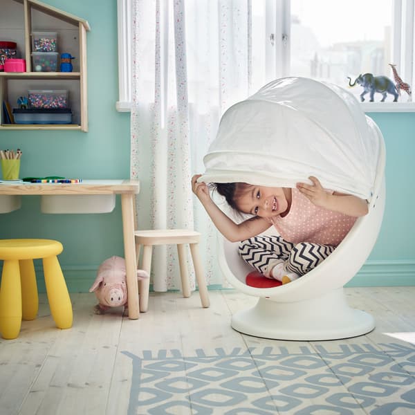 IKEA LÖMSK white swivel armchair with child sitting inside.