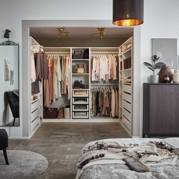 IKEA PAX wardrobe system with KOMPLEMENT felt boxes, white drawers and shelves organise this fashionable walk-in closet.
