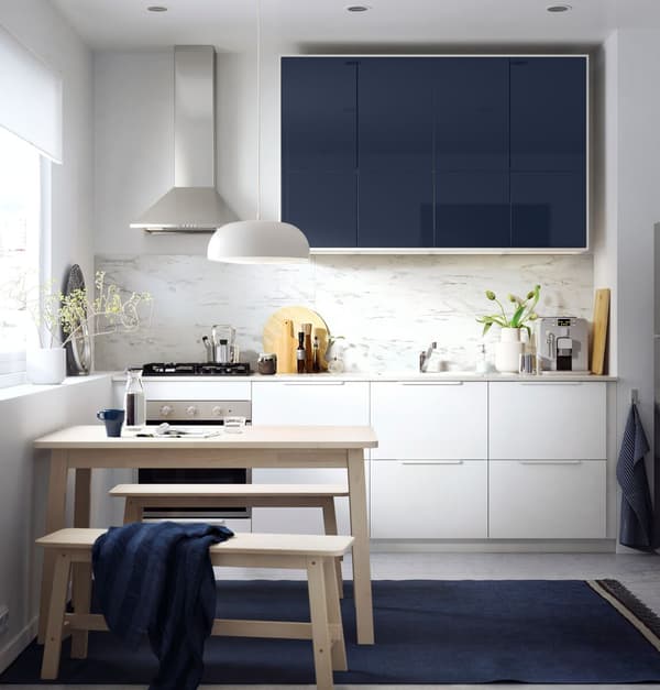 IKEA RINGHULT drawers and JÄRSTA glossy black blue kitchen cabinet fronts in a white minimalist kitchen.