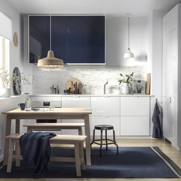 IKEA RINGHULT drawers and JÄRSTA glossy black blue kitchen cabinet fronts in a white minimalist kitchen.