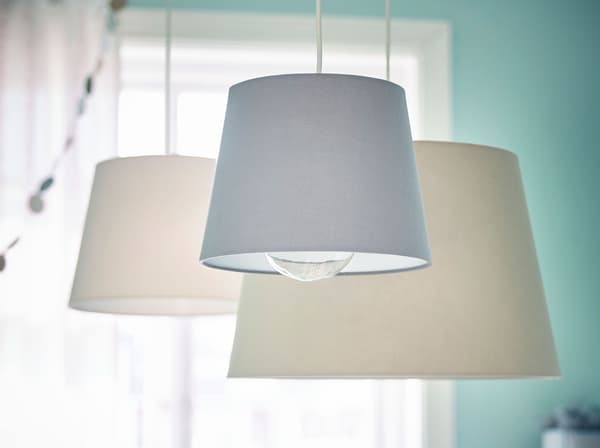 IKEA SINNRIK lamps with plastic bulb protectors.