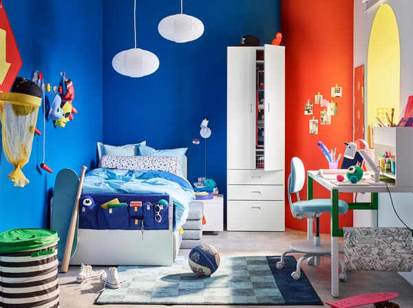 IKEA STUVA white wardrobe and SLÄKT white bed in a brightly coloured children's bedroom.