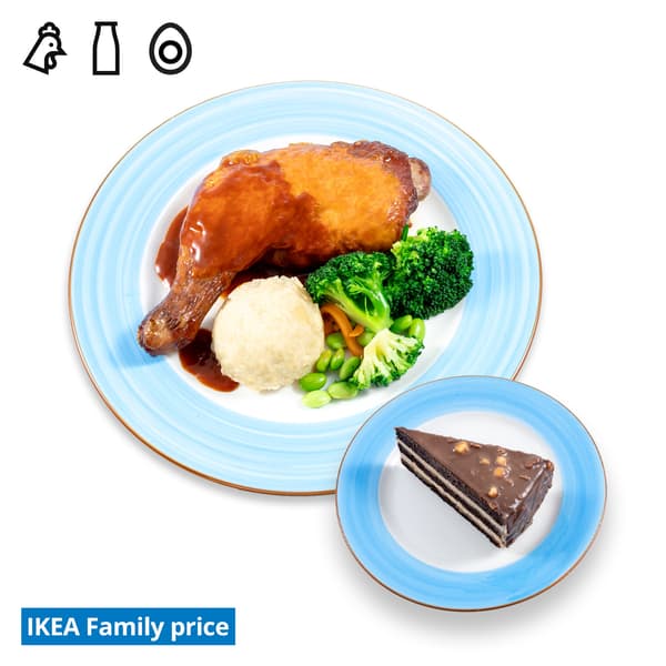 IKEA Tampines Halal Restaurant's IKEA Family offer for Deepavali celebrations— Smoked BBQ Chicken leg with mashed potato & mixed vegetables and a slice of chocolate hazelnut cake. Food allergen symbols of chicken, dairy and egg in black on the top left-hand.  The IKEA Family price tag is displayed in blue and white text, positioned at the bottom left of the image.