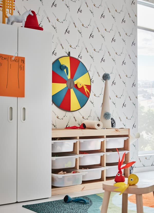 IKEA TROFAST pine and white plastic drawers and LUSTIG dartboard are children’s storage and playtime in one. The lightweight soft toy squids are easy to throw.
