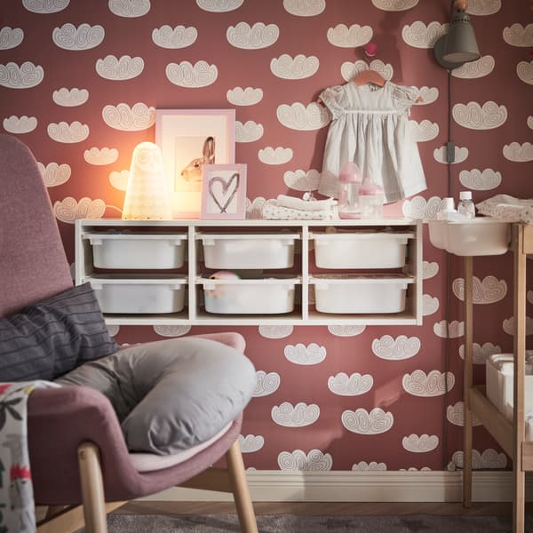 IKEA TROFAST white wall storage unit with six plastic storage bins mounted to the wall.