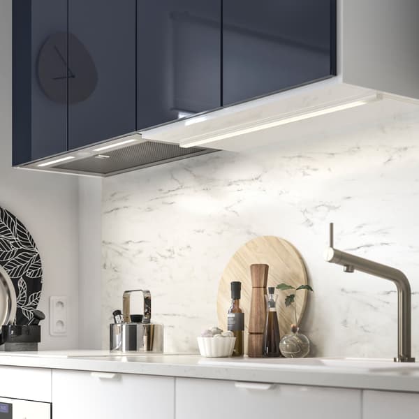 IKEA UNDERVERK kitchen hood, integrated underneath kitchen cabinets. Its halogen bulbs provide lighting to the countertop.