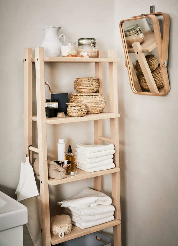 IKEA VILTO towel stand crafted from fine-grained birch, holding bath towels and small woven baskets.