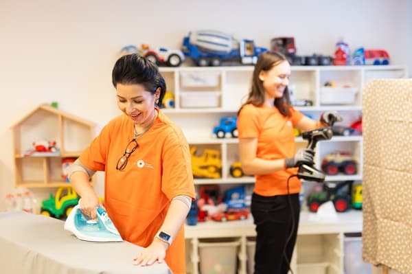 IKEA volunteers bring furniture and interior items into the crisis centre rooms.