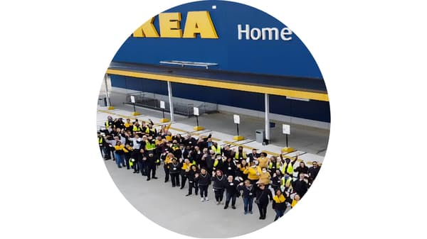 IKEA Woodbridge store front with group of IKEA co-workers waving 