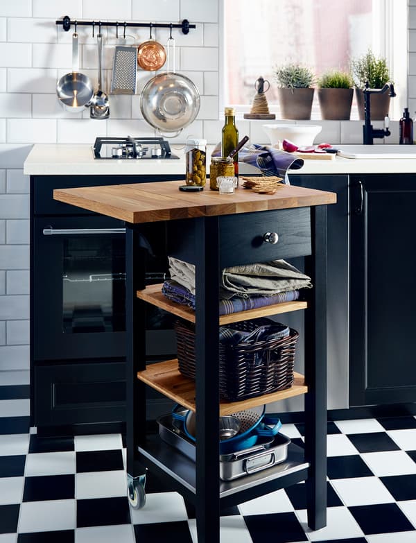 IKEA wooden kitchen trolley with drop-leaf extension being used as a worktop.