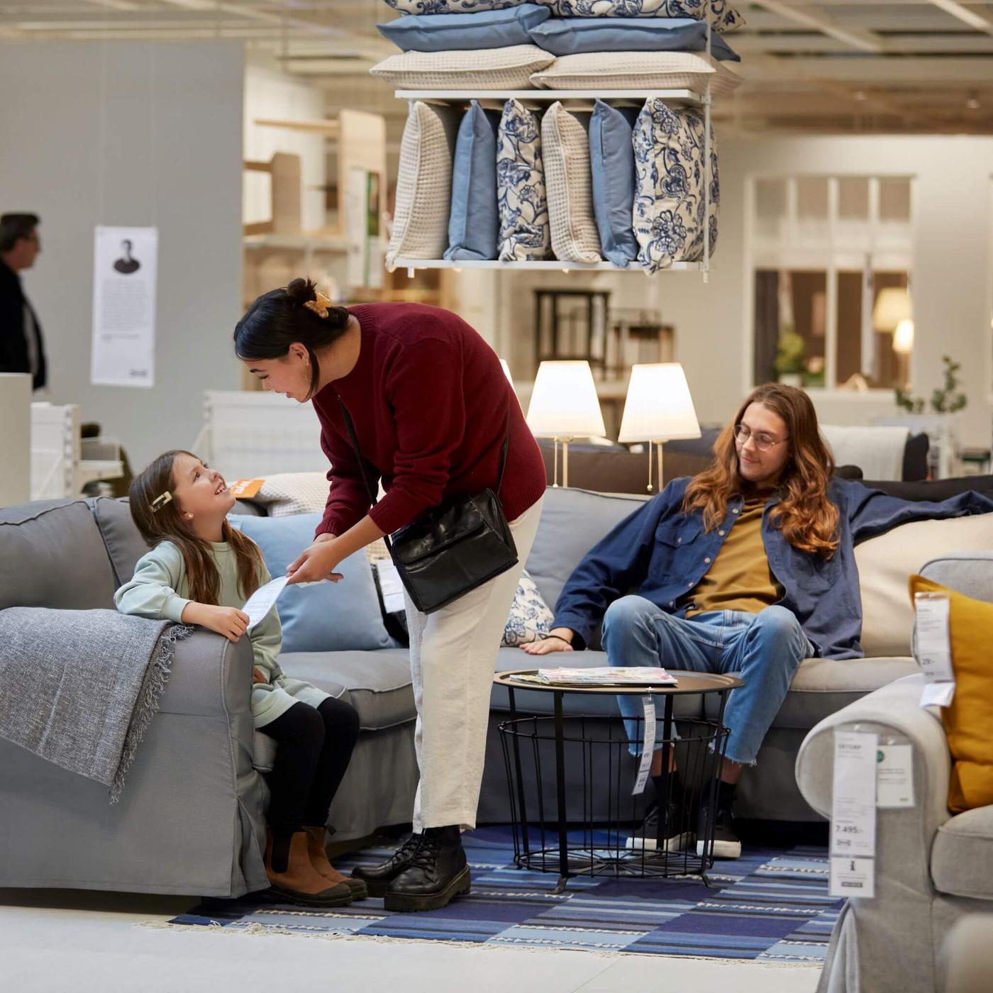 Image of a family testing out at sofa at IKEA
