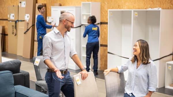 image of a man and women looking chairs in the ikea as-is