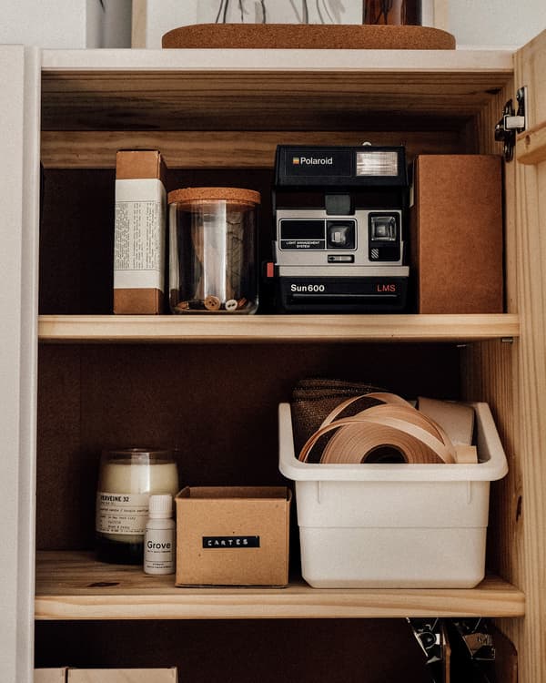 IVAR cupboard filled with various craft items and a camera.