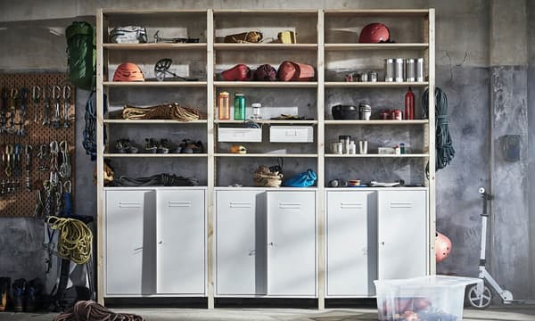 IVAR white shelves with long doors at the bottom, and five open shelves above with different items. 