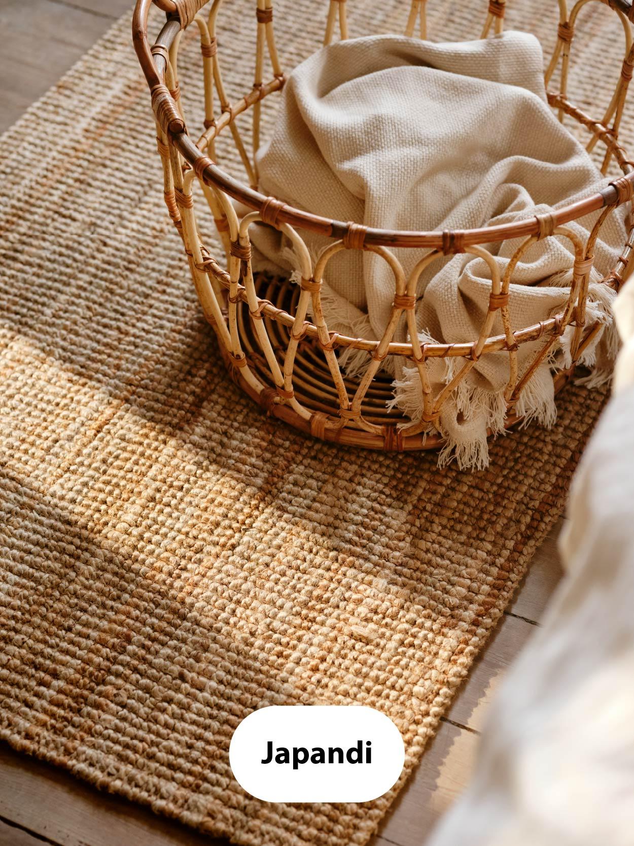 Japandi – Woven jute rug with a wicker basket holding soft neutral fabrics, evoking a minimalist natural aesthetic.