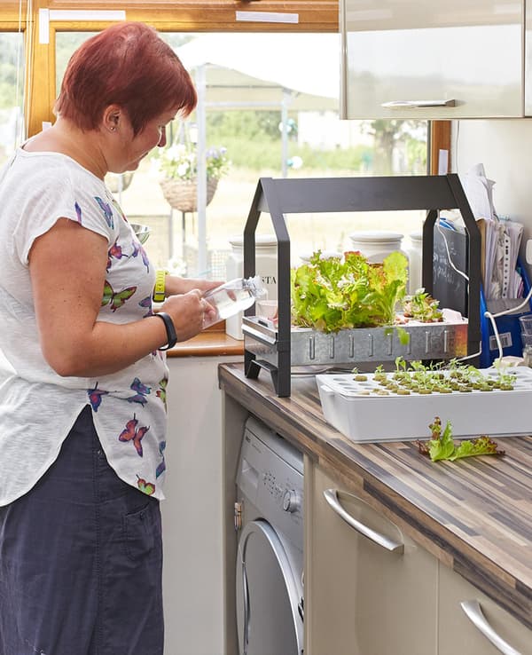 Juliette in her kitchen planting