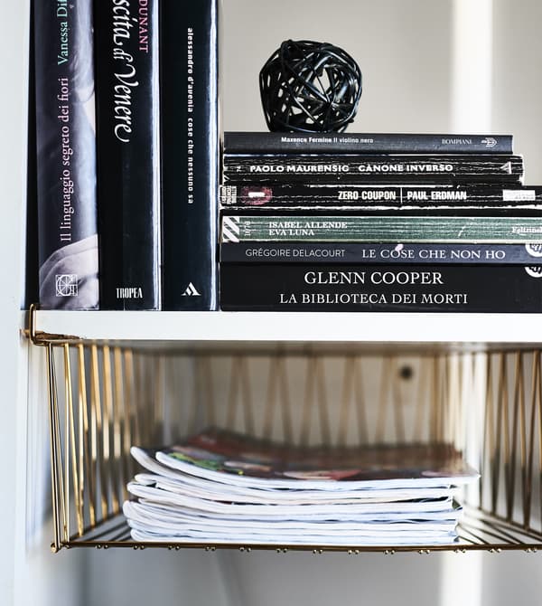KALLAX alcove with basket inserts and books inside.