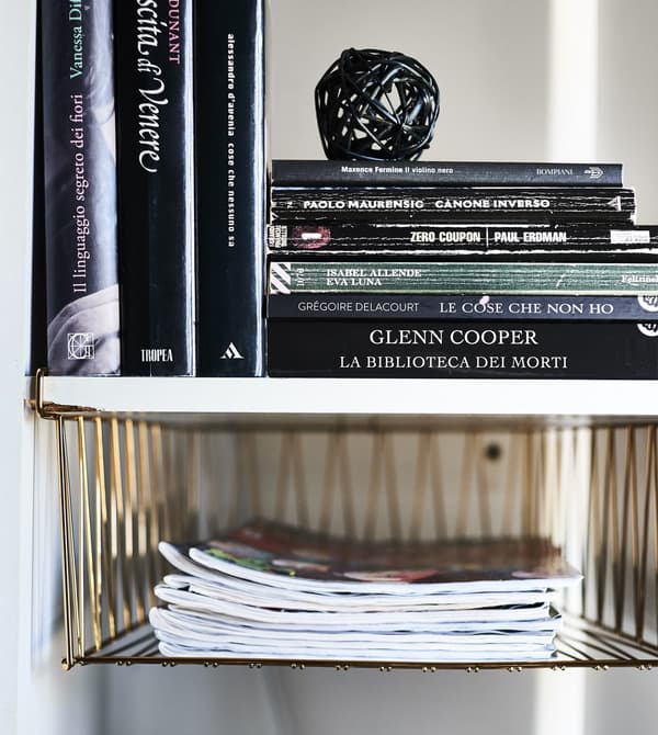 KALLAX alcove with basket inserts and books inside.