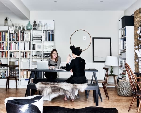 Katie and Elkie working at a table and an open storage unit.