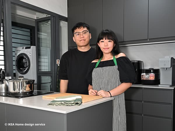 Kelody and Zack photographed in their contemporary kitchen in a 4-room BTO flat in Woodlands
