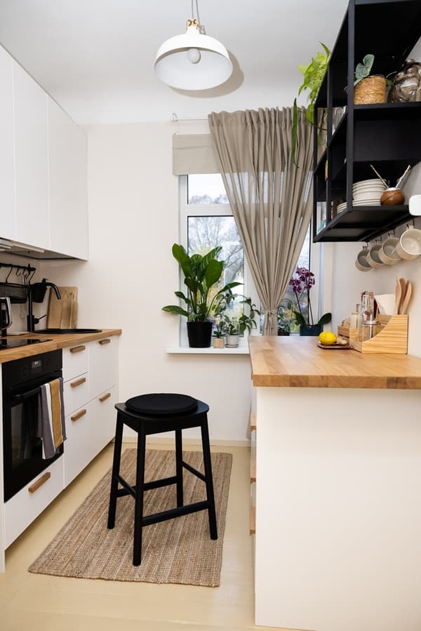 Kitchen work area with drawers under the worktop and a wall shelf for everyday items.