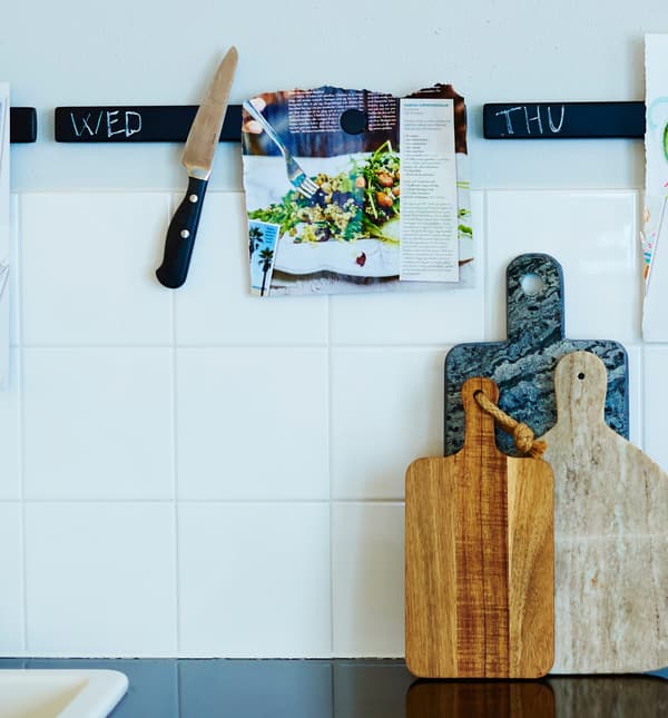 Knife rack painted with chalkboard paint hold knives and recipes.