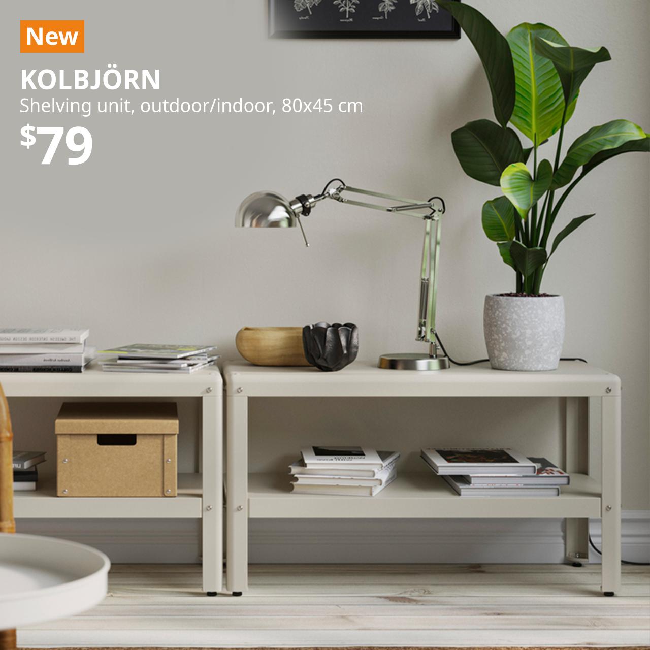 KOLBJORN shelving unit placed side by side, with a FORSA work lamp on top and books placed underneath the shelves in the living room area.Text on image reads New with a orange box, KOLBJORN, shelving unit, outdoor/indoor, 80x45 cm.