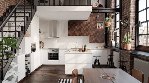 KUNGSBACKA kitchen with anthracite units, and dark grey walls and dining table. Light comes in from a big window.