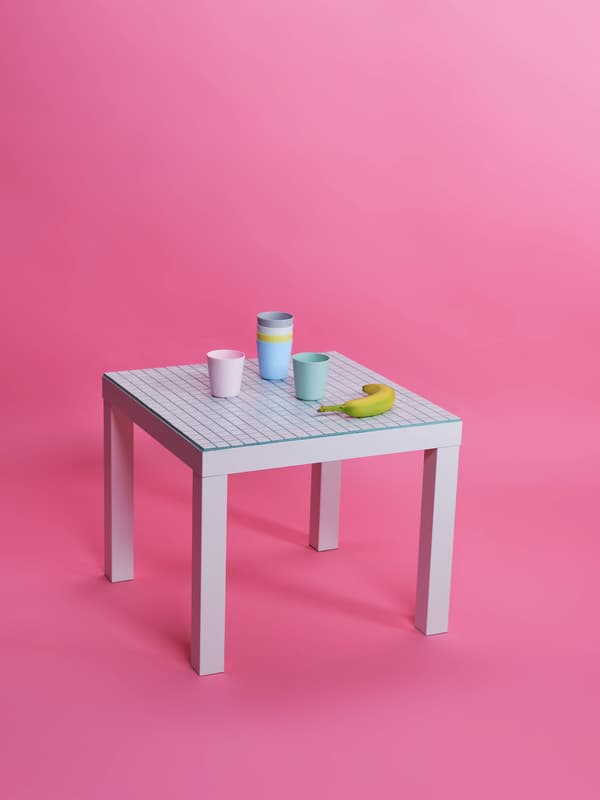 LACK table covered with mosaic tiles and cups on the top.