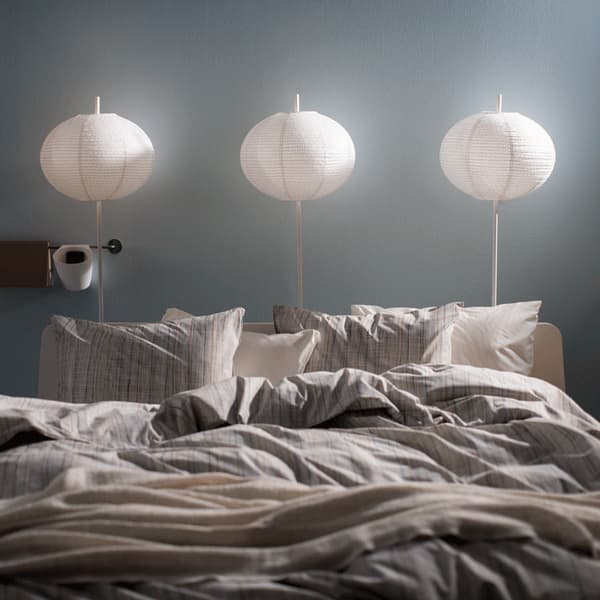 Lamps above a bed turning on in sequence.