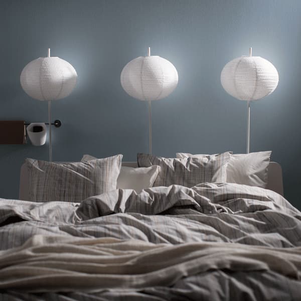 Lamps above a bed turning on in sequence.