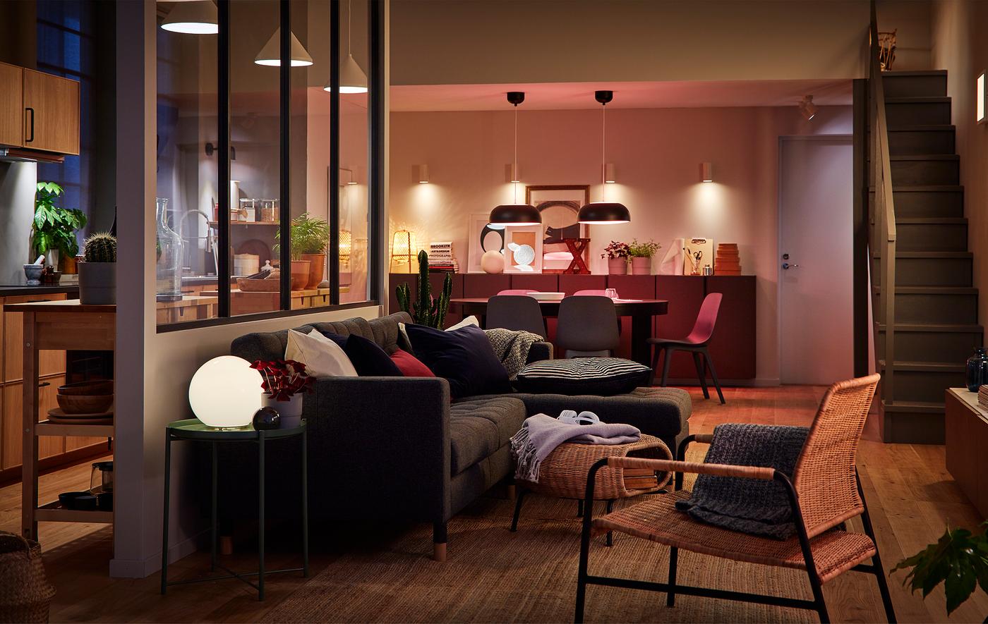 Large open concept space with kitchen, dining area and living room areas, lit by multiple light sources.