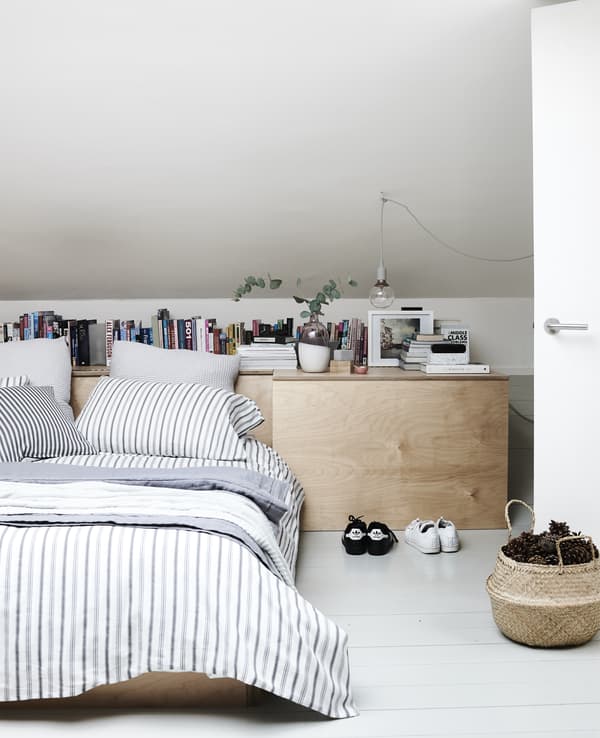 Layers of textiles in a minimal bedroom.