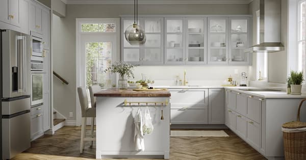 LERHYTTAN light gray kitchen with a kitchen island with wood countertops.