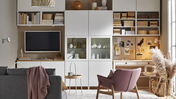 living room with pink chairs and white entertainment center