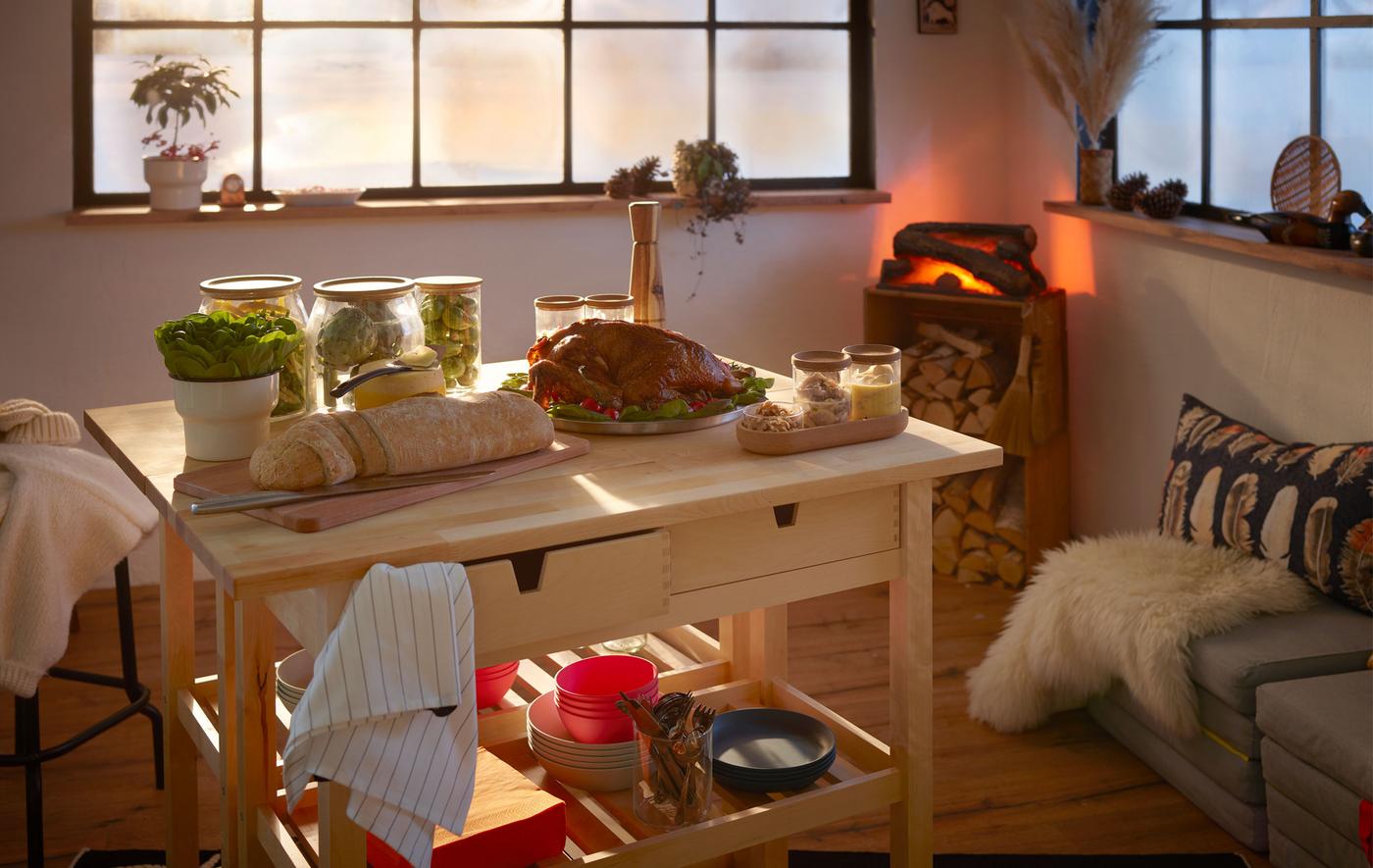Log-cabin style interior with a small but festive buffet set on double kitchen trolleys; fake fireplace in the corner.