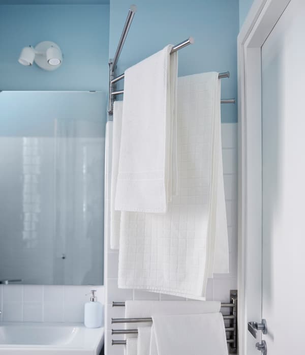 Looking for big storage in a small bathroom? One tip is to use your room’s odd spaces like this towel rack that fits on the corner and behind the door.