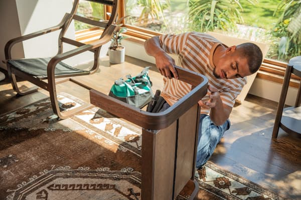 man putting together furniture