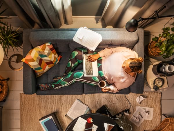 man sitting on couch with laptop