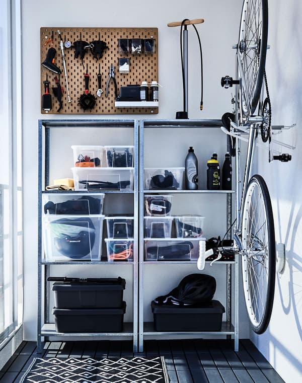 Metal shelving creates a storage space for outdoor gear against the wall of a balcony.