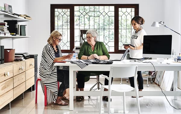 Mia and her colleagues working in her home office.