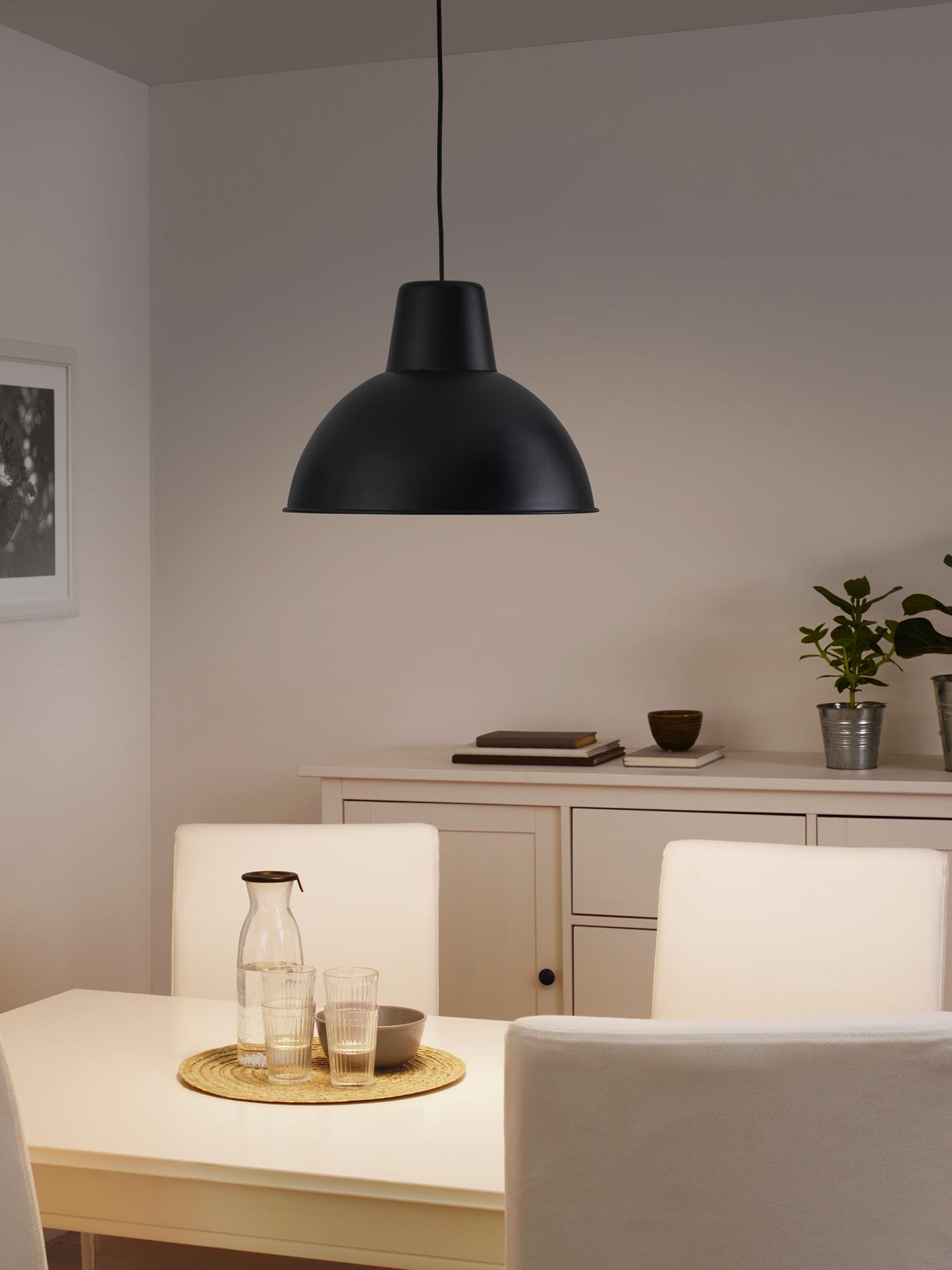 Modern black pendant light hanging above a dining table in a cozy neutral-toned room – Pendant lights from ₹529