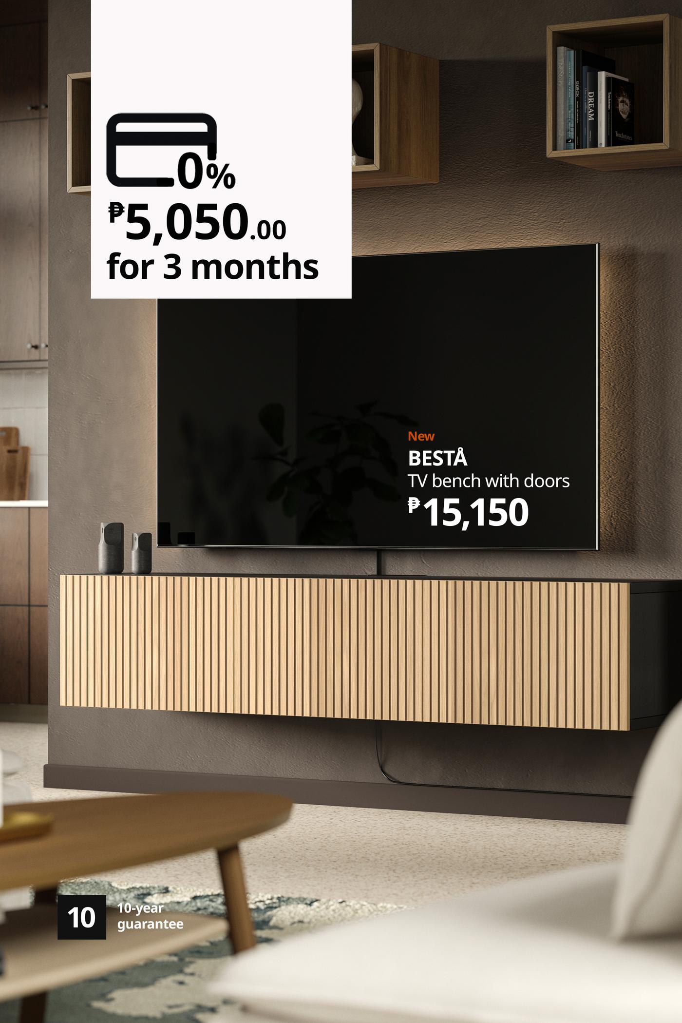 Modern living room with a wall-mounted TV above a slatted BESTÅ TV bench; a graphic advertises 0% interest, ₱5,050 monthly for three months.