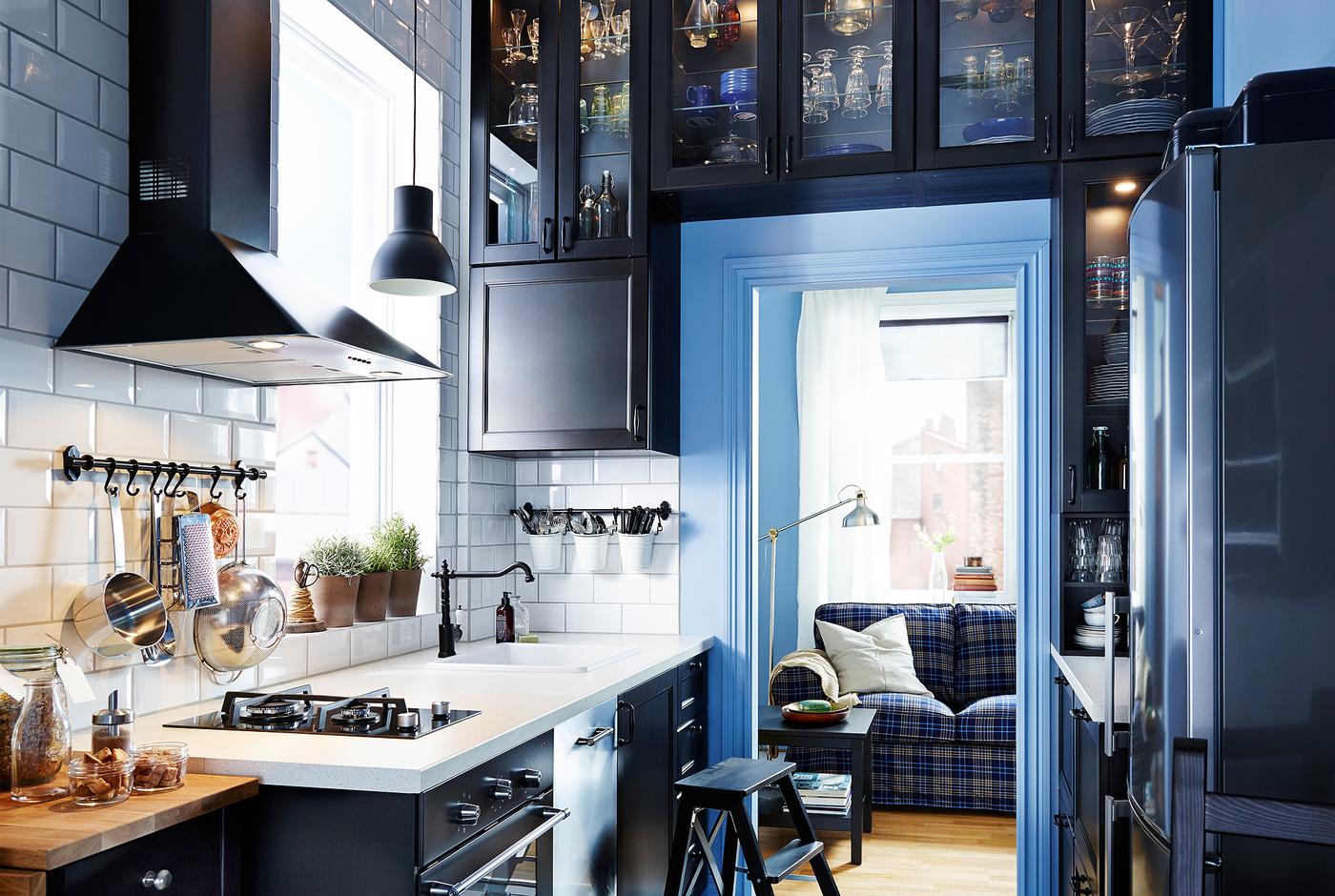 Narrow kitchen with IKEA kitchen cabinets built all around the doorframe.