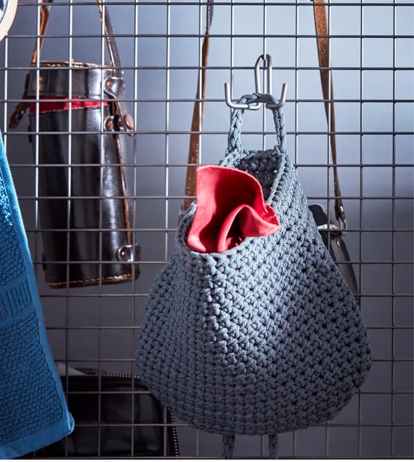 NORDRANA baskets are plastic woven with handles, so you can hang them like on this wire mesh room divider. IKEA has a variety of storage boxes and baskets that you can keep in your room and carry to the bathroom, too.