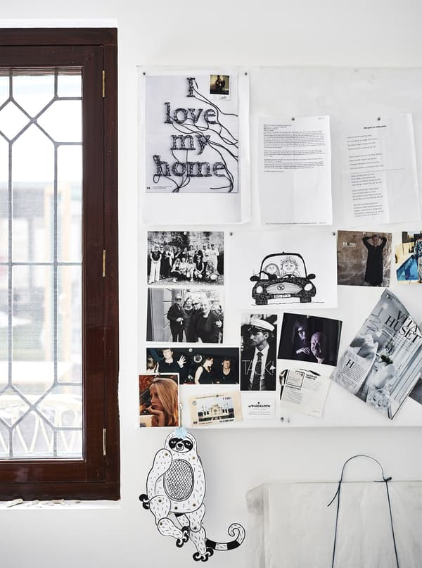 Notes, pictures and photographs on a pinboard.