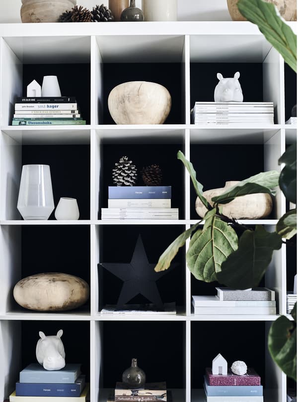 Objects and magazines displayed on a storage unit.