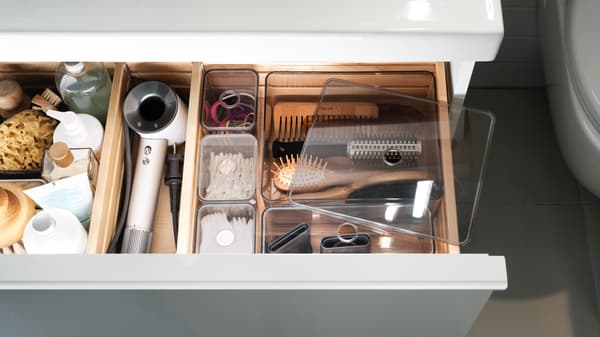 Open bathroom drawer with box with compartments