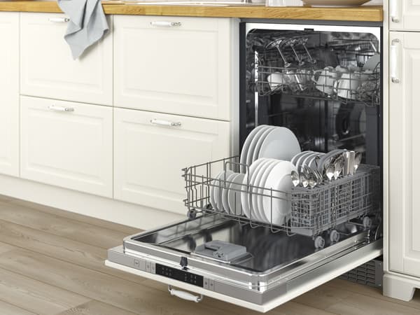 Open dishwasher in a kitchen with clean plates and utensils loaded in the lower and upper racks.